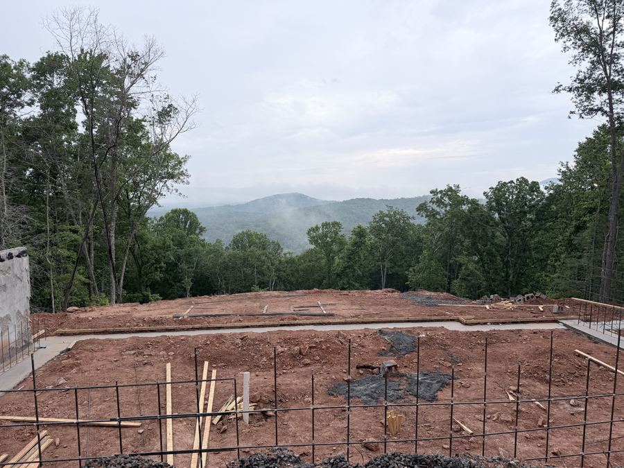 Freshly poured foundation at Ritzy Ridge with mountain views beyond